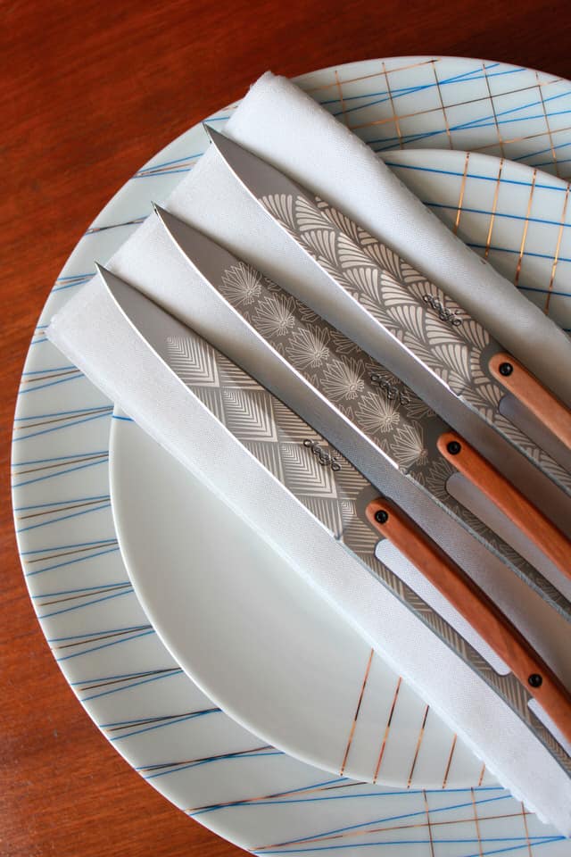 Lifestyle shot of Deejo art decor knives on table setting