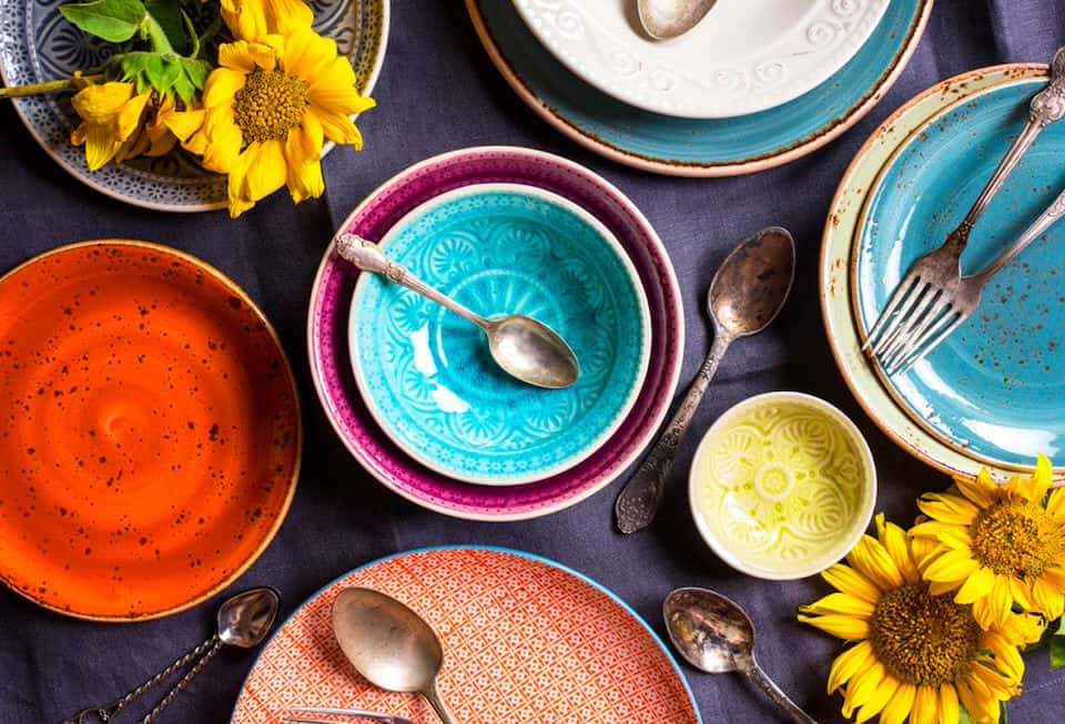 Main homepage cover image of empty colourful tableware with vintage cutlery